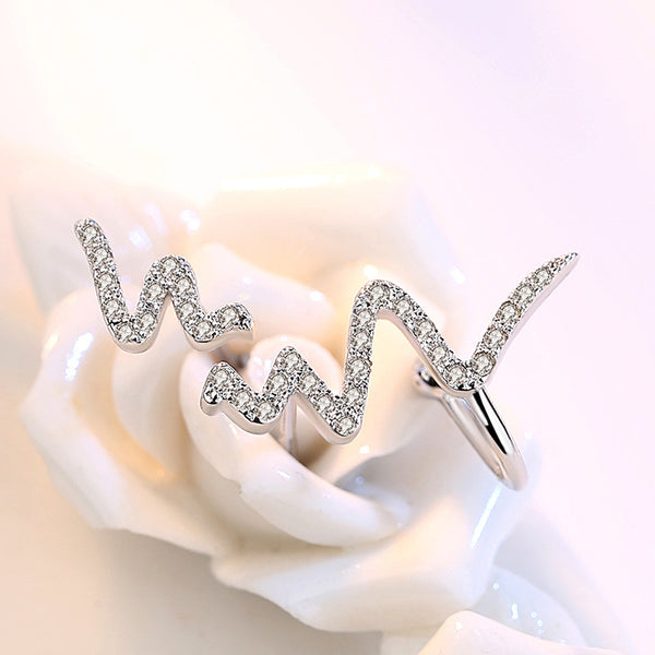 Silver necklace with an ECG heartbeat line pendant, adorned with small clear stones on a simple link chain. - Image 3