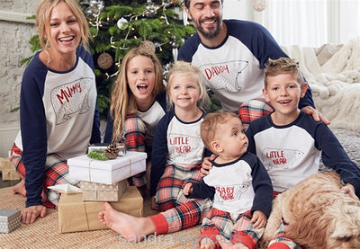 Family of four wearing matching Christmas pajamas with white and navy bear print tops and red plaid pants. - Image 4