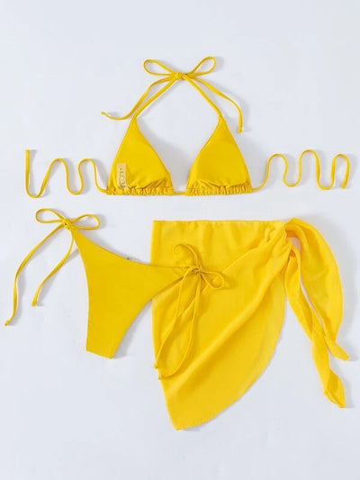 Neon yellow three-piece bikini set with triangle cup lace-up top, tie-side bottom, and matching sarong, displayed with a straw hat and sunglasses. - Image 20