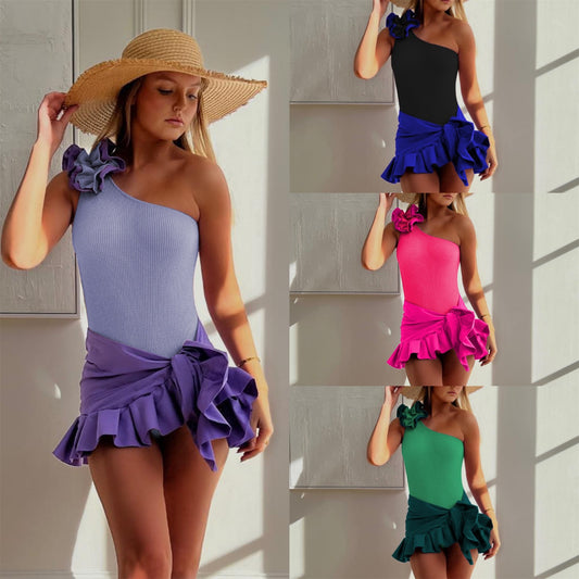 Black one-shoulder ribbed one-piece swimsuit with a ruffled blue and black strap, ideal for women's swimwear.