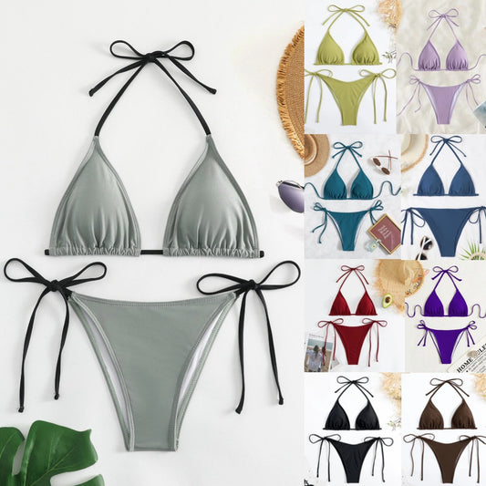 Neon yellow halter bikini with triangle top and tie-side bottoms, displayed on a light wood surface.