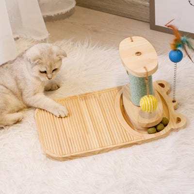 White cat playing with a wooden multi-level track toy featuring a spring-mounted yellow feather ball and a green catnip ball. - Image 18