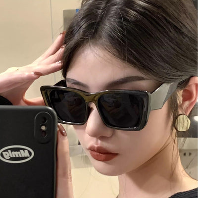 Retro cat-eye sunglasses with a vibrant orange frame, brown temples, and light champagne-colored lenses. - Image 12