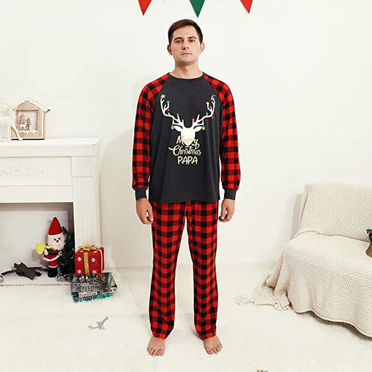 Woman wearing a Christmas pajama set with a dark gray 'Merry Christmas MOMMY' reindeer top and red and black plaid pants. - Image 3