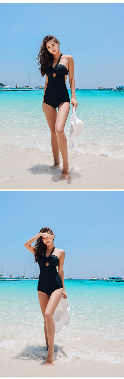 Woman wearing a taupe ribbed one-piece swimsuit with a halter neckline and twisted bust detail on a sandy beach. - Image 19