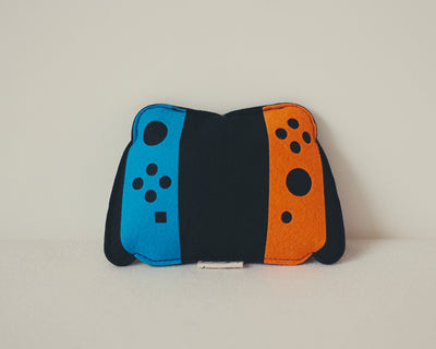 Light blue felt catnip toy shaped like a game controller with piano keys and a black string for hanging. - Image 13