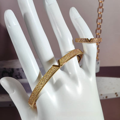 V-shaped 18K gold electroplated bracelet and ring set with pave clear stones on a white stand. - Image 10