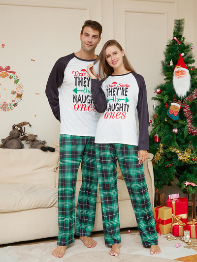 Man wearing a white and black raglan long-sleeve pajama top with a 'Dear Santa They're the Naughty Ones' graphic and green plaid pajama pants. - Image 3