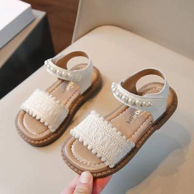 Children's white sandals with pearl ankle straps, woven front strap, and brown sole, featuring a Velcro closure. - Image 3