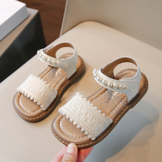 Children's white sandals with pearl ankle straps, woven front strap, and brown sole, featuring a Velcro closure. - Image 3