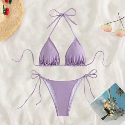 Neon yellow halter bikini with triangle top and tie-side bottoms, displayed on a light wood surface. - Image 11