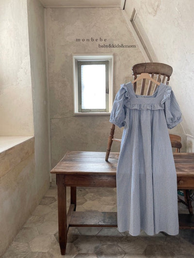 Light blue and white gingham baby romper with puff sleeves and ruffled square neckline, hanging on a wooden chair. - Image 10