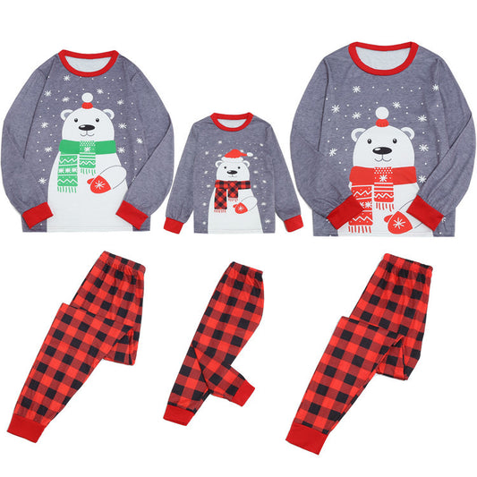 Family of five wearing matching gray and red buffalo plaid Christmas pajamas with polar bear print. - Image 2