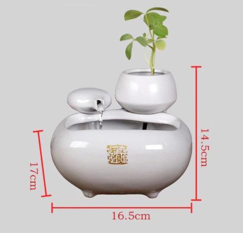 White ceramic flowing water fountain ornament with an integrated planter holding a green plant. Features gold Chinese characters. - Image 9