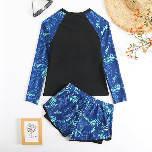 Women's long-sleeve tankini swimsuit with black top and blue tropical leaf print raglan sleeves, matching swim shorts. - Image 12