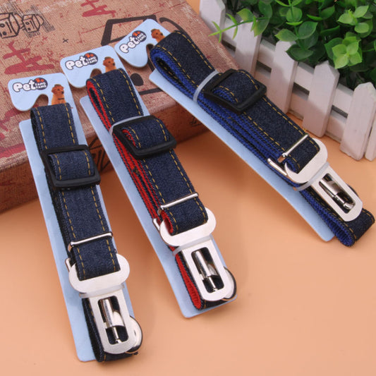 Dark blue denim pet car seat belt with yellow stitching, metal buckle, and plastic adjuster on a hanger.
