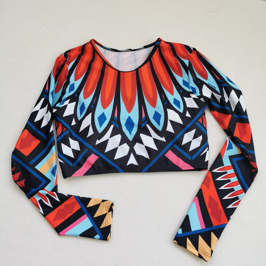 Women's long-sleeve crop top and high-waisted bikini set with a vibrant red, blue, black, and white feather-like geometric pattern. - Image 3