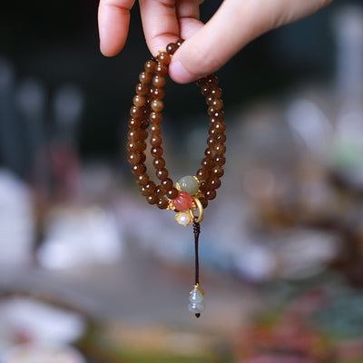 Pulsera de Tres Aros con Perla de Calabaza y Mariposa - Image 9