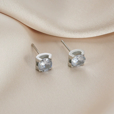 Delicate silver-colored chain necklace with a single square-cut clear stone pendant in a four-prong setting on a woman's neck. - Image 11