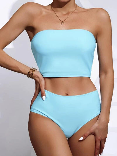 Vibrant orange strapless bandeau bikini top and high-waisted bottoms set, worn by a woman with a white shirt. - Image 13