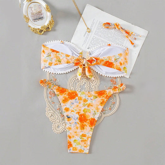 Orange floral print bandeau bikini with pom-pom trim and high-cut thong bottom with side rings. - Image 8