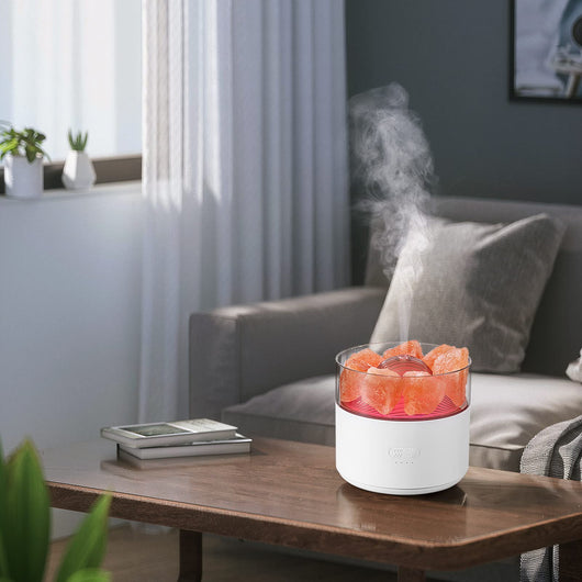 White cool-mist humidifier and aroma diffuser with glowing blue LED lights and orange crystal salt rocks, emitting mist. - Image 4