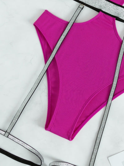 Pink one-piece swimsuit with side cut-outs and sparkling silver garter straps, modeled by a woman. - Image 11