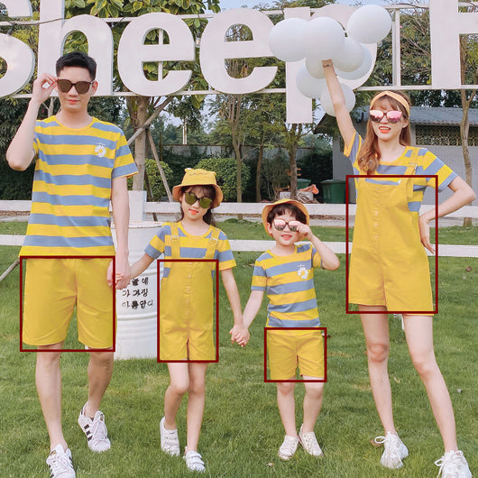 Family of four wearing matching yellow and blue striped t-shirts with daisy appliques. Mother and daughter wear yellow short overalls, father and son wear yello - Image 2