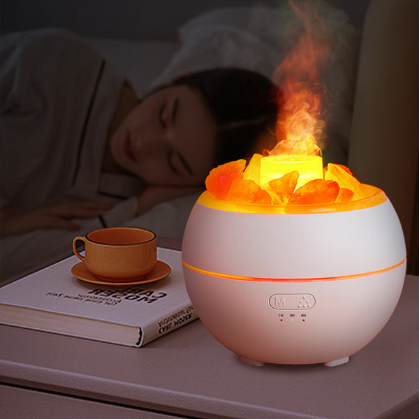White spherical aromatherapy machine with glowing salt stones and a simulated flame effect on a white background.