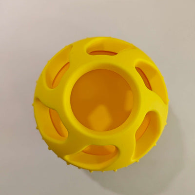 Bright yellow silicone pet toy ball with an open-cage design, ideal for slow feeding and teeth cleaning.
