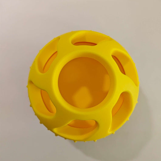 Bright yellow silicone pet toy ball with an open-cage design, ideal for slow feeding and teeth cleaning.