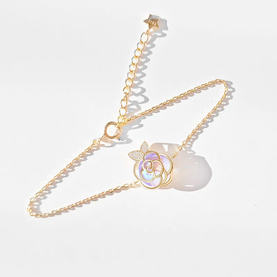 Gold-tone necklace with an iridescent camellia flower pendant and small clear stones on a delicate chain. - Image 9