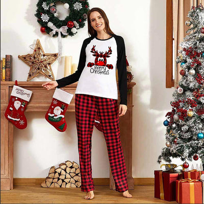 Family matching Christmas pajamas with a deer graphic and "Merry Christmas" text on white and black tops, paired with red and black buffalo plaid pants. - Image 7