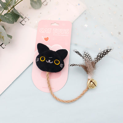 White cat head plush teaser toy with hemp rope, gold bell, and natural spotted feathers on pink packaging. - Image 5