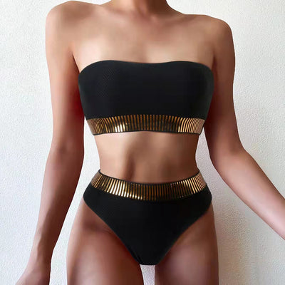 Black bandeau bikini with gold striped trim and matching high-waisted bottoms on a white surface. - Image 10