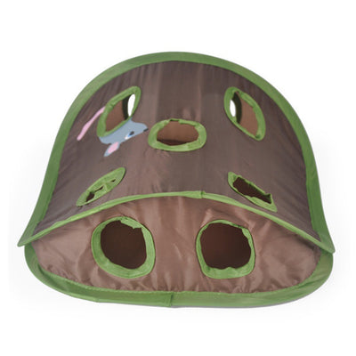 Grey tabby kitten playing with a brown and green hide-and-seek cat toy with multiple holes and a mouse graphic. - Image 3
