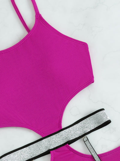 Pink one-piece swimsuit with side cut-outs and sparkling silver garter straps, modeled by a woman. - Image 9