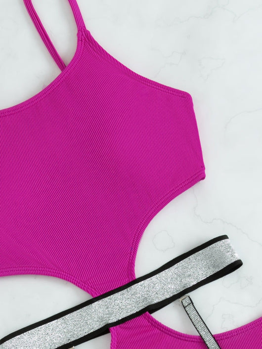 Pink one-piece swimsuit with side cut-outs and sparkling silver garter straps, modeled by a woman. - Image 9