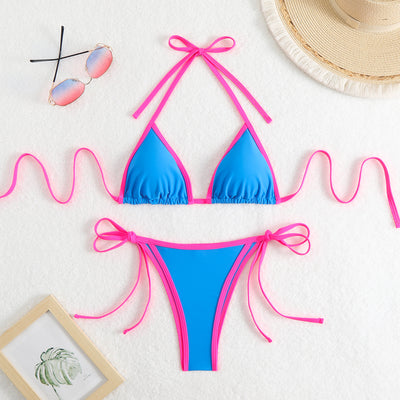 Royal blue two-piece bikini with light blue trim and tie straps, laid flat on a white textured surface. - Image 11