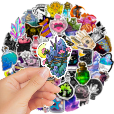 A hand holds a gothic-themed sticker featuring a raven, skull, and crystals, with a pile of 50 assorted waterproof stickers in the background. - Image 4