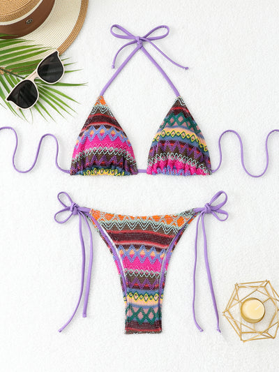 Black and white knitted zigzag bikini with triangle halter top and tie-side bottoms on a marble surface. - Image 7