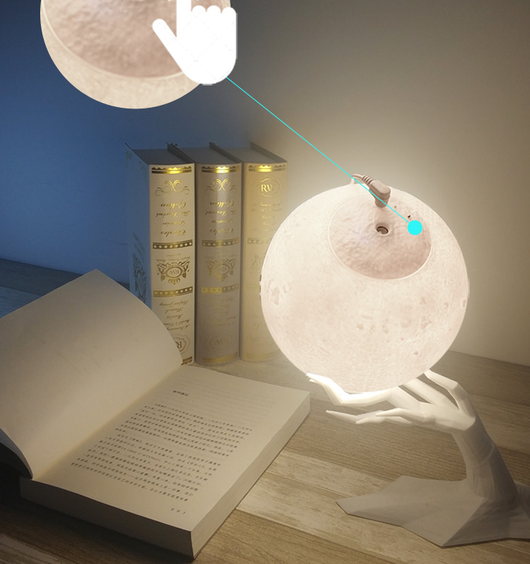 Moon-shaped humidifier and night light with a white deer stand, emitting mist, on a wooden table with books. - Image 13