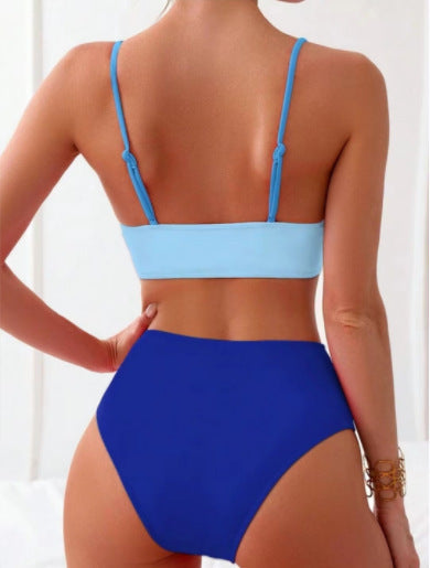 Woman wearing a blue color block split swimsuit with a wrapped front bikini top and high-waisted briefs. - Image 13