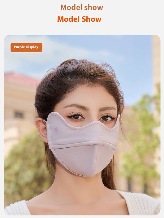 Woman wearing a grey outdoor cycling wind mask with ear hooks and a small heart logo, designed for cold-proof eye protection. - Image 25