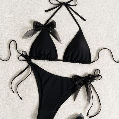 Black strappy backless bikini two-piece swimsuit for women with triangle top and tie-side bottoms, featuring sheer polka dot bows. - Image 4