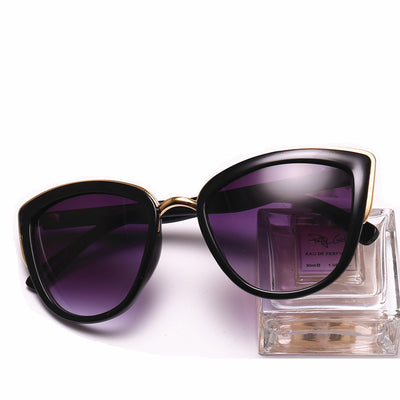 Black cat-eye sunglasses for women with gradient grey lenses and subtle gold-tone metal accents on the frame. - Image 2