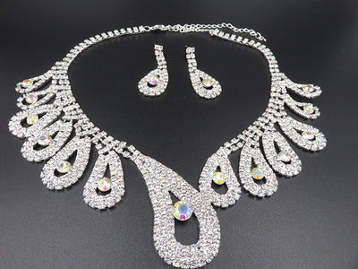 Silver-toned rhinestone necklace and matching drop earrings set with iridescent accents, ideal for bridal or formal wear. - Image 4