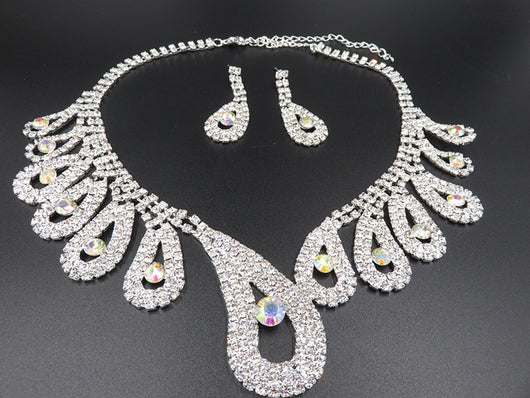 Silver-toned rhinestone necklace and matching drop earrings set with iridescent accents, ideal for bridal or formal wear. - Image 4