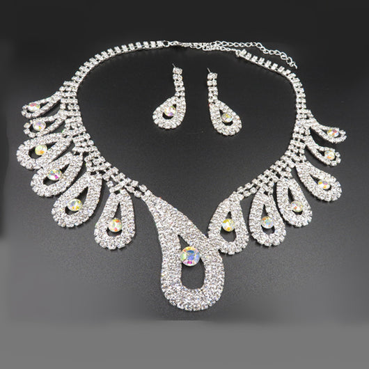 Silver-toned rhinestone necklace and matching drop earrings set with iridescent accents, ideal for bridal or formal wear. - Image 6