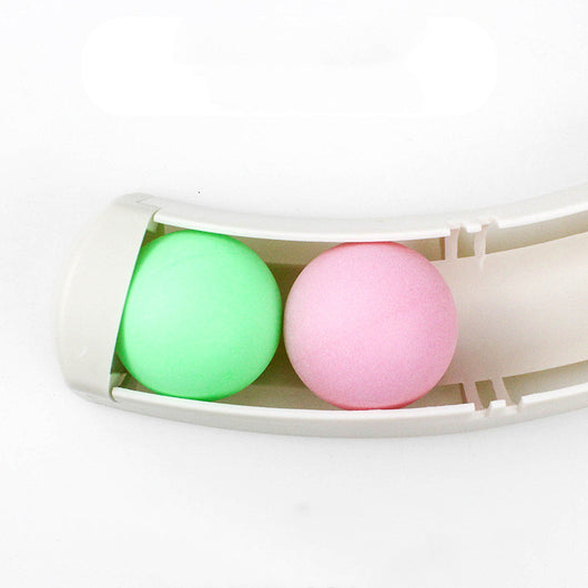 White curved track cat toy with green and pink balls, mounted on a blue wall, with two cats playing. - Image 3
